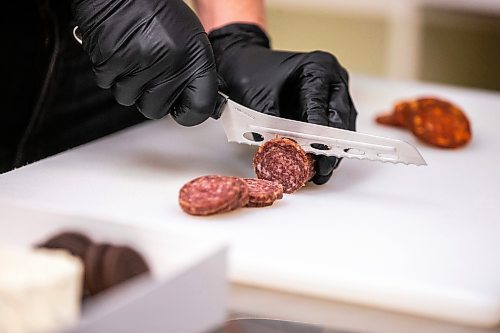 MIKAELA MACKENZIE / WINNIPEG FREE PRESS

Megan McMaster, owner of charcuterie shop Peckish, assembles a piece in her store in Winnipeg on Wednesday, April 19, 2023. For Dave Sanderson story.

Winnipeg Free Press 2023.