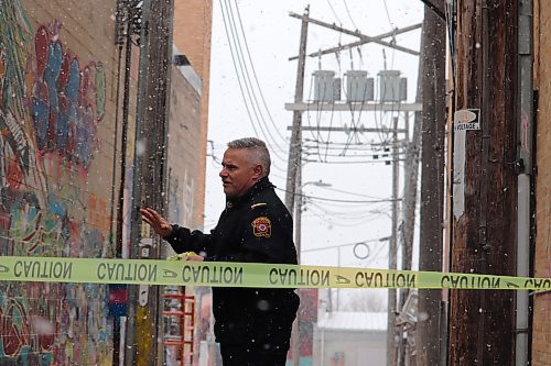 Brandon Fire and Emergency Services Capt. Terry Browett puts some caution tape up near the scene of a blown transformer that knocked out power to a large chunk of the city’s downtown core Thursday morning. (Kyle Darbyson/The Brandon Sun)