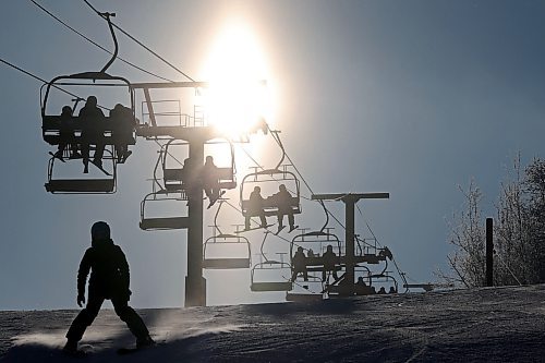 03012023
Skiers and snowboarders are silhouetted by the sun while riding the chair lift at Asessippi Ski Resort on a sunny Tuesday. (Tim Smith/The Brandon Sun)