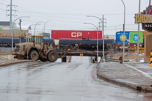 Mike Deal / Winnipeg Free Press
Crews from the WFPS and CP Rail attend a train derailment at the McPhillips Street underpass Friday morning. McPhillips Street will be closed for most of the day. 
230421 - Friday, April 21, 2023.