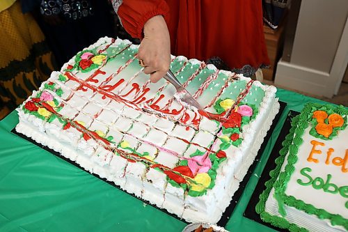 Saira Atif cuts a cake during Eid al-Fitr. (Tim Smith/The Brandon Sun)