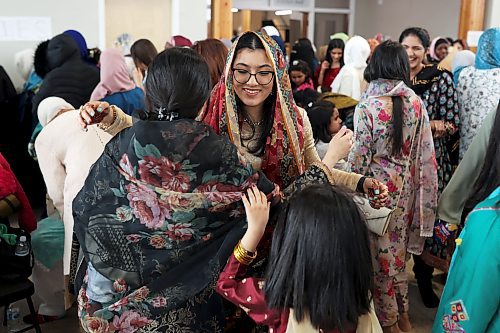 Sophiya Mehdi hugs a friend at an Eid al-Fitr celebration in Brandon on Friday. (Tim Smith/The Brandon Sun)