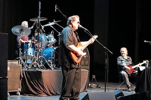 Rich Dodson, guitarist for The Stampeders, performs on stage alongside Kim Berly (drums) and Ronnie King (bass) at the Brandon's Western Manitoba Centennial Auditorium on Saturday night. (Kyle Darbyson/The Brandon Sun)