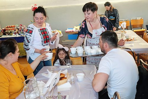 Tryzub volunteers hand out some green borscht during Saturday's Borscht Fest fundraising event at the Ukrainian National Hall in Brandon. (Kyle Darbyson/The Brandon Sun)