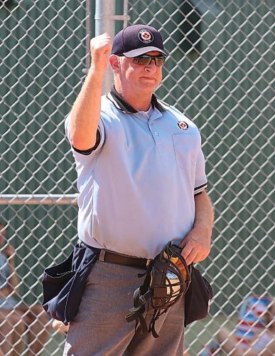 Softball umpire-in-chief Bruce Leubke signals an out at a game at the Ashley Neufeld Softball Complex last summer. He wishes there were a few more umpires in the massive area he serves. (Perry Bergson/The Brandon Sun)