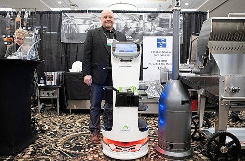 JESSICA LEE / WINNIPEG FREE PRESS

Bob Kolt poses for a portrait with a robot server at the Victoria Inn April 25, 2023 during the Manitoba Hotel Association and Manitoba Foodservices and Restaurant Association trade show.

Reporter: Gabby Piche