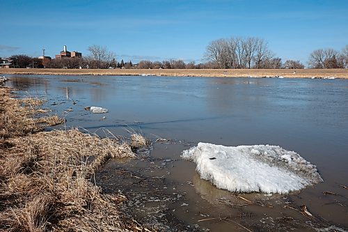 Ice clings to the shore of the swollen Assiniboine River in Brandon on Tuesday. The city's new draft climate change action plan aims to reach net-zero by 2050. (Tim Smith/The Brandon Sun)