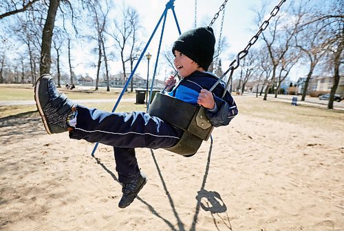 25042023
Dominic Hernandez swings at Stanley Park while enjoying the playground with family on a warm Tuesday. (Tim Smith/The Brandon Sun)