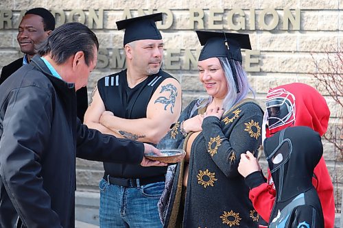 LINKS Institute graduates Colin Partridge and Luana Hebert take part in a smudging ceremony at the Riverbank Discovery Centre Thursday morning right before receiving their mental wellness and harm reduction worker diplomas. (Kyle Darbyson/The Brandon Sun)