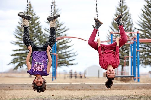 Blake Blacksmith and Elsa Shingoose play on the swings at the Sioux Valley Dakota Nation powwow grounds during a walk by the Grade 3 class at Sioux Valley Elementary School to learn about structures in the community on Friday. (Tim Smith/The Brandon Sun)