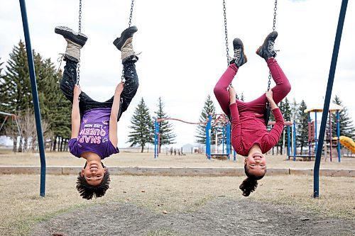 280423
Blake Blacksmith and Elsa Shingoose hang around on the swings at the Sioux Valley Dakota Nation pow wow grounds during a walk by the grade three class at Sioux Valley Elementary School to learn about structures in the community on Friday.  (Tim Smith/The Brandon Sun)