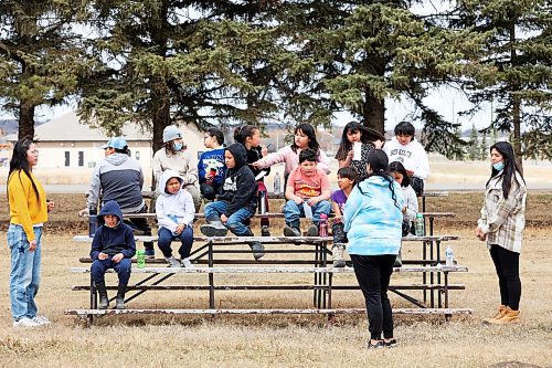280423
Grade three students from Sioux Valley Elementary School take a break on a set of bleachers at the pow wow grounds during a walk with their teacher Memory Blackbird (blue sweatshirt) and Educational Assistants Angel Allen (L) and Chloe Blacksmith (R) to learn about structures in the community on Friday.  (Tim Smith/The Brandon Sun)