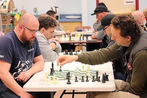 Brandon Knights Chess Club secretary Alex Murray faces off with Tyler Tegg at the Western Manitoba Regional Library in Brandon on Saturday afternoon. (Kyle Darbyson/The Brandon Sun)
