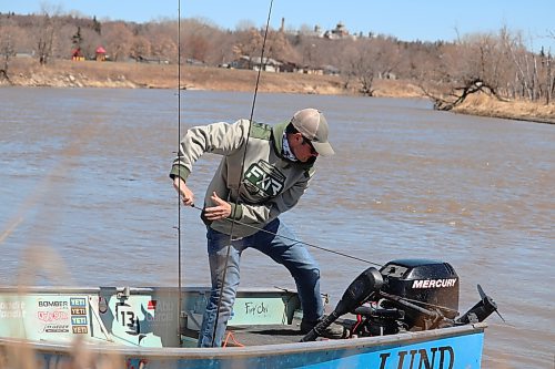 Matt Lintott launches his fishing boat onto the Assiniboine River in Brandon during a windy Monday afternoon. Lintott said he likes to get a head-start on the summer fishing season by running his boat in the spring to troubleshoot any mechanical issues. (Kyle Darbyson/The Brandon Sun)