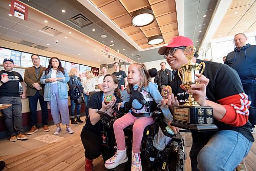 Mike Sudoma/Winnipeg Free Press
Smile Cookie Ambassador, Braelynn Bodman poses with Tyler Mags (right) and Mandy Shew (left) of Virgin 103.1 after winning a trophy during a cookie decorating contest as part of Smile Cookie Week
May 1, 2023