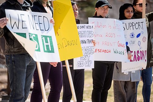 Mike Sudoma/Winnipeg Free Press
Rally attendees hold up signs during a University of Manitoba Walkout protest Monday
May 1, 2023