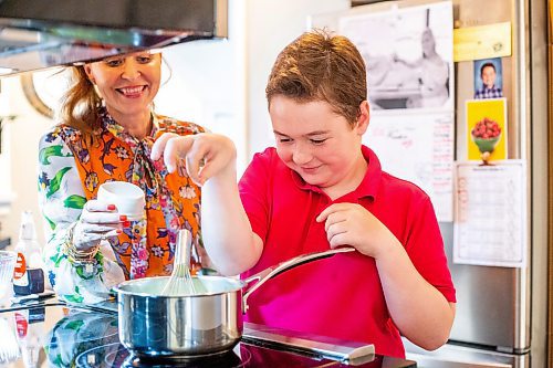 MIKAELA MACKENZIE / WINNIPEG FREE PRESS
 
Jack Taylor, 10, sprinkles a pinch of salt into lemon curd for mini cheesecakes with his mom, Meghan, in Winnipeg on Monday, May 1, 2023. For Eva story.

Winnipeg Free Press 2023.