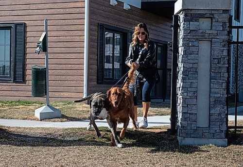 JESSICA LEE / WINNIPEG FREE PRESS

Carla Martin and her daughter&#x2019;s dogs Louie (brown coat) and Georgia (dark brown coat) are photographed May 2, 2023 near their Bridgwater home. Martin was walking Louie and Georgia Monday morning near Kenaston Boulevard when they were surprised by three coyotes.

Reporter: Chris Kitching