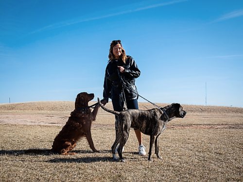 JESSICA LEE / WINNIPEG FREE PRESS

Carla Martin and her daughter&#x2019;s dogs Louie (brown coat) and Georgia (dark brown coat) are photographed May 2, 2023 near their Bridgwater home. Martin was walking Louie and Georgia Monday morning near Kenaston Boulevard when they were surprised by three coyotes.

Reporter: Chris Kitching