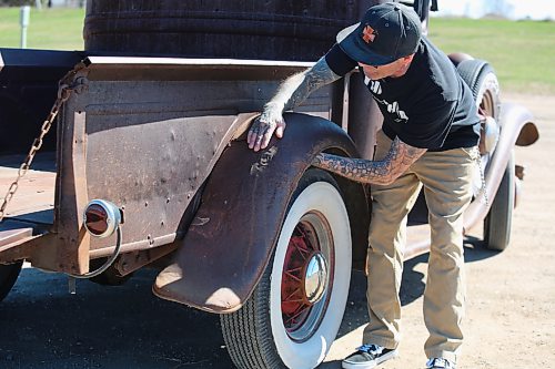 Curt Stauffer examines the repair from a past fender bender on his 1932 Truck Model B, flathead V8 engine and three speed manual transmission at Dinsdale Park on Thursday. (Michele McDougall, The Brandon Sun) 