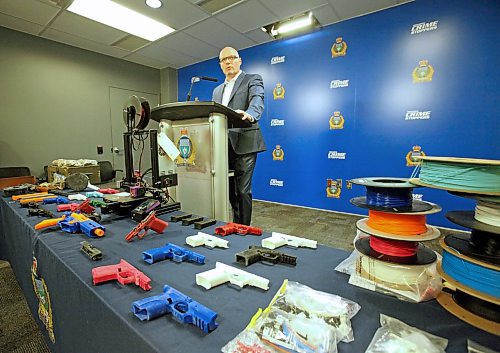 Winnipeg Police Service organized crime Insp. Elton Hall speaks to reporters Thursday behind a display of 3D-printed gun receivers and parts seized from an alleged manufacturer on March 31. ERIK PINDERA/WINNIPEG FREE PRESS