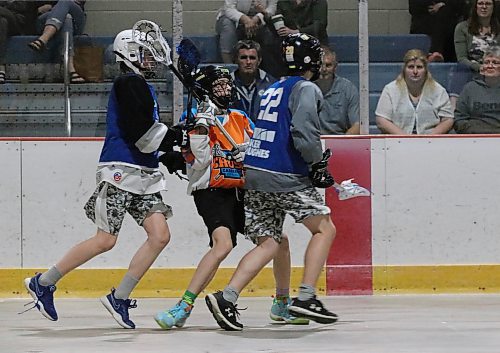 Dayde Pearce (18) of the Carberry Crush, centre, is surrounded by Wheat City Wranglers defenders Jaxon Derlago, left and Cash Zdan, right (22) during an under-14 game at Flynn Arena last summer. The sport is finding its way back after losing two summers to the pandemic. (Perry Bergson/The Brandon Sun)