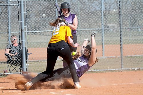 Vikings Ryan DeGroot slides safely under the tag of Lang for a home run as her team improved to 2-0. (Thomas Friesen/The Brandon Sun)