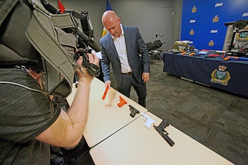 Winnipeg Police Service organized crime Insp. Elton Hall shows off examples of 3D-printed handgun receivers city cops and American law enforcement agency the Bureau of Alcohol, Tobacco and Firearms made as training devices to television news cameras. ERIK PINDERA/WINNIPEG FREE PRESS
