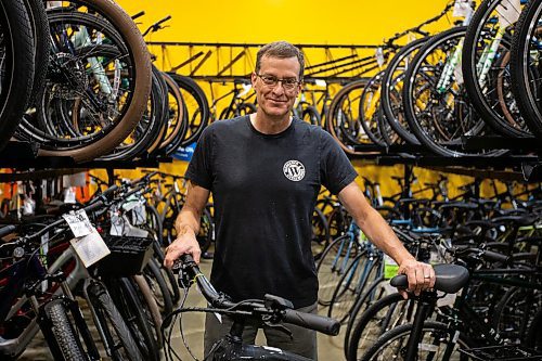 Daniel Crump / Winnipeg Free Press. Tim Woodcock, owner of Woodcock Cycle Works, shows off some of the e-bikes that he stocks at his St. Vital store. July 8, 2022.