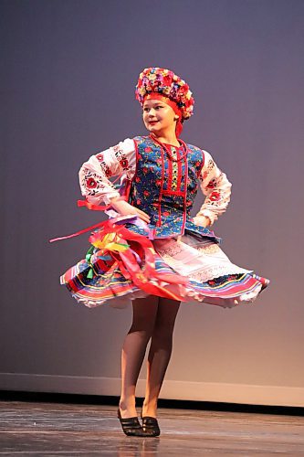 Kyra Borgfjord, representing Arborg's Reechka Ukrainian Dance Club, performs onstage at the Western Manitoba Centennial Auditorium during the opening day of the Brandon Troyanda School of Ukrainian Dance's 2023 dance festival. This three-day competition, which runs from Friday to Sunday, features roughly 1,000 dancers and instructors from 29 different clubs throughout Manitoba and Saskatchewan. (Kyle Darbyson/The Brandon Sun)