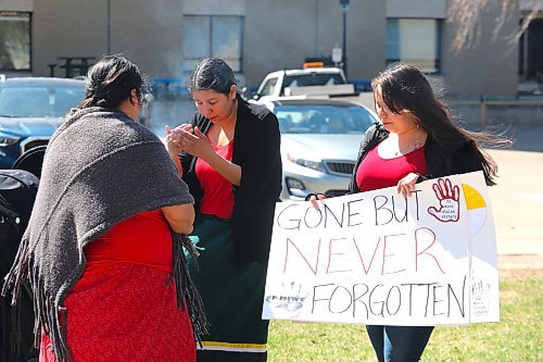 Cree knowledge keeper Susie McPherson-Derendy conducts a smudging ceremony during Friday's Red Dress Day ceremony at Brandon University. (Kyle Darbyson/The Brandon Sun)