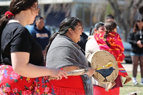 Cree knowledge keeper Susie McPherson-Derendy sings a women's warrior song during Brandon University's Red Dress Day ceremony on campus. (Kyle Darbyson/The Brandon Sun)