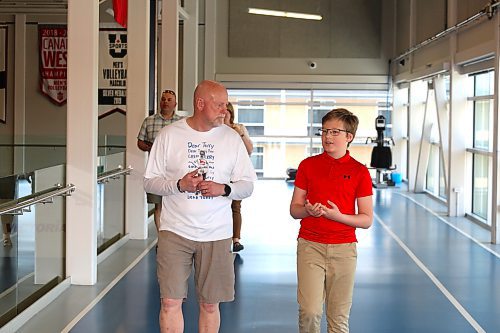 Fred Fox, brother of Terry Fox, walks around the Healthy Living Centre track Saturday afternoon alongside St. Augustine School student Max Wronowski. Fred Fox visited the Wheat City over the weekend to promote this year’s Terry Fox Run, which will be held at Brandon University. (Kyle Darbyson/The Brandon Sun)