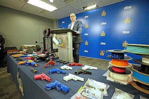 Winnipeg Police Service organized crime Insp. Elton Hall speaks to reporters Thursday behind a display of 3D-printed gun receivers and parts seized from an alleged manufacturer on March 31. ERIK PINDERA/WINNIPEG FREE PRESS