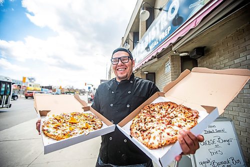 MIKAELA MACKENZIE / WINNIPEG FREE PRESS
 
Owner Vince Bignell holds taco (left) and North Ender pizzas outside of Shelly's Indigenous Diner in Winnipeg on Friday, May 5, 2023. For Dave story.

Winnipeg Free Press 2023.