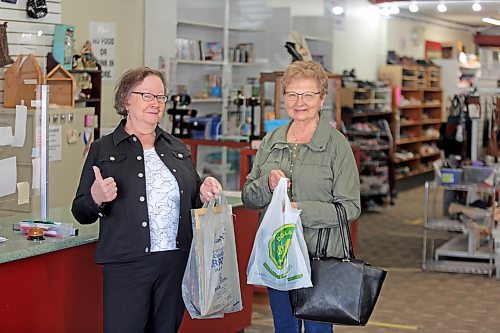 Lillian Kostiw and Jeanette Popien are happy with their purchases from the Nearly New Shop in Brandon on Tuesday. (Michele McDougall/The Brandon Sun)  