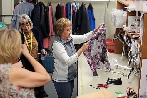 Eileen Mosson, member of the Brandon Regional Health Centre (BRHC) Auxiliary, checks one of the latest donations at the Nearly New Shop in Brandon on Tuesday. (Michele McDougall/The Brandon Sun) 