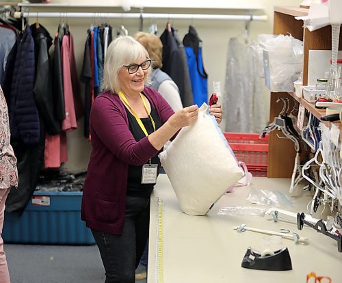 Barb Barrie, a member of the Brandon Regional Health Centre (BRHC) Auxiliary makes a quick fix to a pillow donated to the Nearly New Shop on Tuesday. (Michele McDougall/The Brandon Sun)