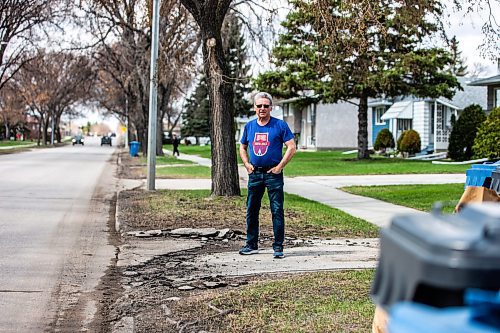 MIKAELA MACKENZIE / WINNIPEG FREE PRESS
 
Eugene Osudar poses by his damaged driveway, which he says was broken by the city&#x573; street cleaning equipment, in Winnipeg on Tuesday, May 9, 2023. For &#x460;story.

Winnipeg Free Press 2023.