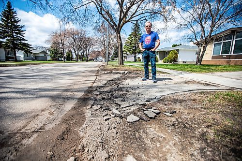 MIKAELA MACKENZIE / WINNIPEG FREE PRESS
 
Eugene Osudar poses by his damaged driveway, which he says was broken by the city&#x573; street cleaning equipment, in Winnipeg on Tuesday, May 9, 2023. For &#x460;story.

Winnipeg Free Press 2023.