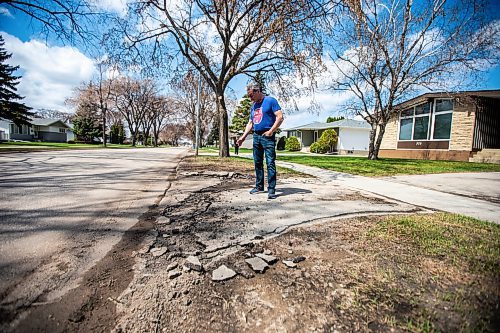 MIKAELA MACKENZIE / WINNIPEG FREE PRESS
 
Eugene Osudar shows his damaged driveway, which he says was broken by the city&#x573; street cleaning equipment, in Winnipeg on Tuesday, May 9, 2023. For &#x460;story.

Winnipeg Free Press 2023.