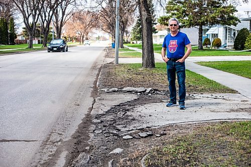 MIKAELA MACKENZIE / WINNIPEG FREE PRESS
 
Eugene Osudar poses by his damaged driveway, which he says was broken by the city&#x573; street cleaning equipment, in Winnipeg on Tuesday, May 9, 2023. For &#x460;story.

Winnipeg Free Press 2023.