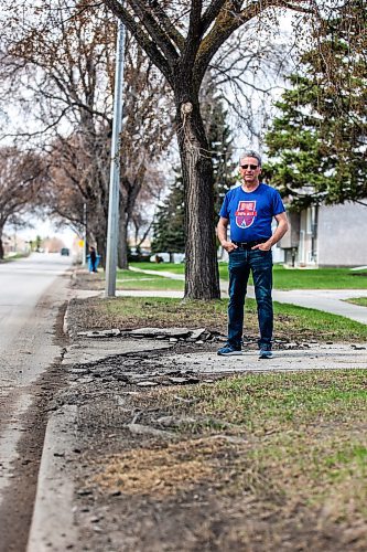 MIKAELA MACKENZIE / WINNIPEG FREE PRESS
 
Eugene Osudar poses by his damaged driveway, which he says was broken by the city&#x573; street cleaning equipment, in Winnipeg on Tuesday, May 9, 2023. For &#x460;story.

Winnipeg Free Press 2023.