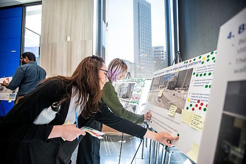 MIKAELA MACKENZIE / WINNIPEG FREE PRESS
 
Abi McLaren (left) and Shay Harder attend an open house on Portage and Main on Wednesday, May 10, 2023. The event, at the lobby of 201 Portage Ave., allowed Winnipeggers to weigh in on several ideas to revitalize the controversial intersection. For Joyanne/GA story.

Winnipeg Free Press 2023.