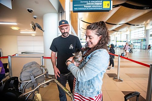 MIKAELA MACKENZIE / WINNIPEG FREE PRESS
 
Eva Wasney and her partner, Neal Leithead, hold kittens from K9 Advocates Manitoba as the crates are scanned before going on a plane to Toronto in Winnipeg on Wednesday, May 3, 2023. For Eva story.

Winnipeg Free Press 2023.