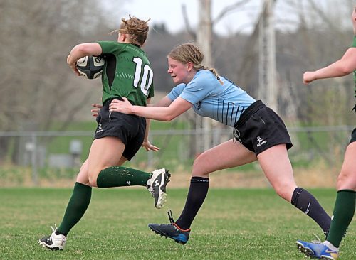 Rivers Rams' Kennedy Wood, right, tackles Dauphin Clippers' Bree Walker during their Westman High School Rugby varsity girls' game at John Reilly Field on Thursday. (Thomas Friesen/The Brandon Sun)