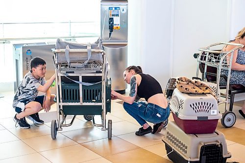 MIKAELA MACKENZIE / WINNIPEG FREE PRESS
 
Silas Marasigan (10, left) and Chelsea Caron say goodbye to the kittens they fostered before the felines get transported to Toronto for K9 Advocates Manitoba at the airport in Winnipeg on Wednesday, May 3, 2023. For Eva story.

Winnipeg Free Press 2023.