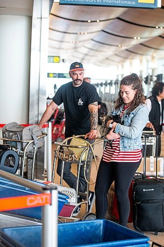 MIKAELA MACKENZIE / WINNIPEG FREE PRESS
 
Eva Wasney and her partner, Neal Leithead, hold kittens from K9 Advocates Manitoba as the crates are scanned before going on a plane to Toronto in Winnipeg on Wednesday, May 3, 2023. For Eva story.

Winnipeg Free Press 2023.