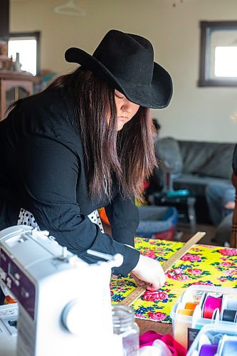 MIKAELA MACKENZIE / WINNIPEG FREE PRESS
 
Marlena Muir, founder of Metis Superstar Designs, works on a skirt in her home where she makes contemporary ribbon skirts in Selkirk on Wednesday, May 10, 2023. For Dave story.

Winnipeg Free Press 2023.