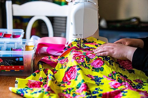 MIKAELA MACKENZIE / WINNIPEG FREE PRESS
 
Marlena Muir, founder of Metis Superstar Designs, works on a skirt in her home where she makes contemporary ribbon skirts in Selkirk on Wednesday, May 10, 2023. For Dave story.

Winnipeg Free Press 2023.